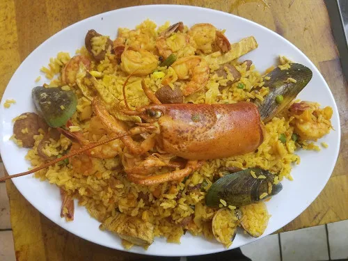 Seafood rice with a whole lobster tail and shellfish