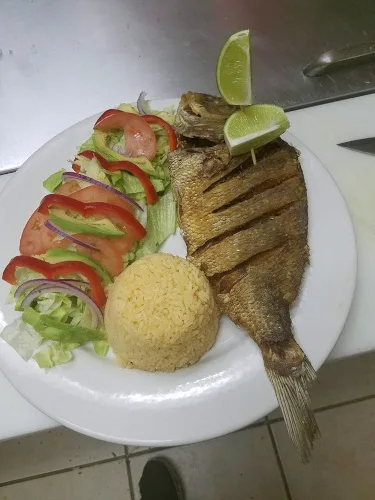 Whole grilled fish with lime, salad and rice