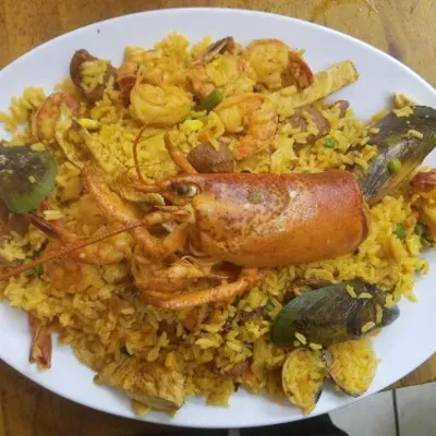 Seafood rice with a whole lobster tail, shrimp and mussels