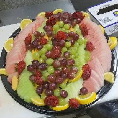 A fruit platter of watermelon, grapes and citrus slices